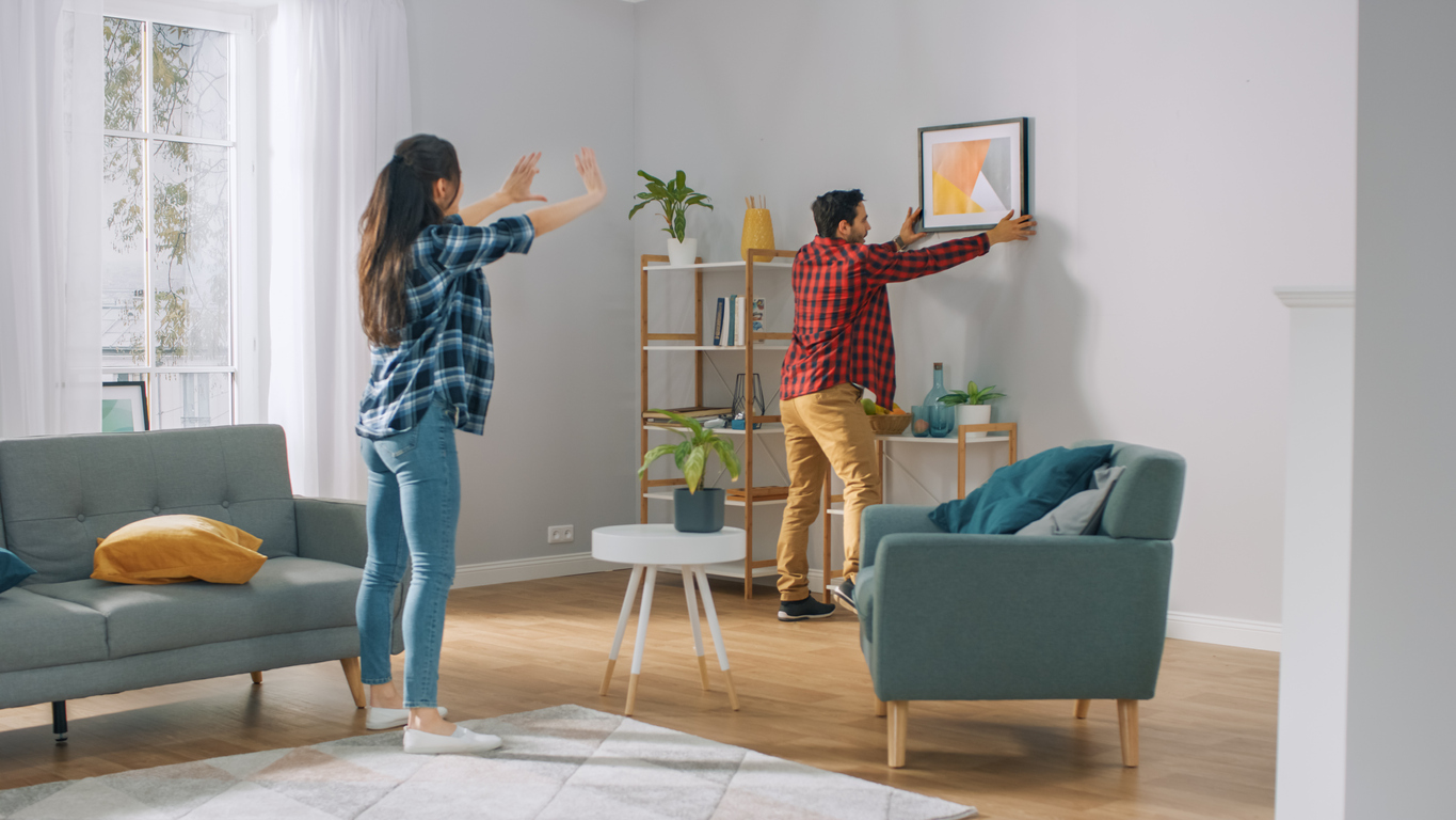 hanging a photo in their first home.